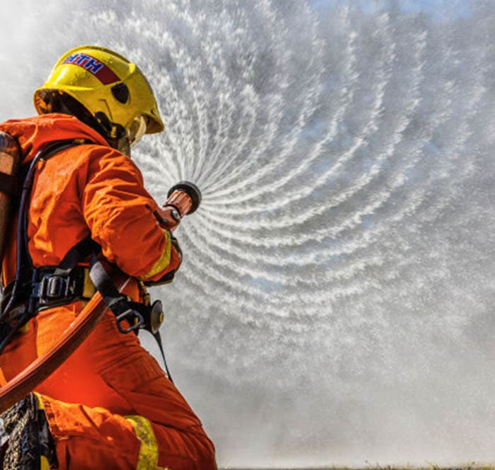 fire fighter with adjustable hand nozzle spraying water